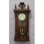 A 19th century Vienna twin weight wall clock striking on a gong.