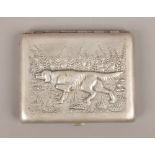 A white metal cigarette case decorated in relief with a pointer and pair of partridges.