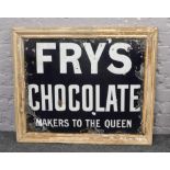 A vintage enamel Fry's Chocolate advertising sign (white text on blue back ground) in later frame.