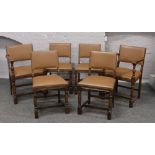 A set of four plus two carver arm dining chairs with fawn leather seats and back rest.