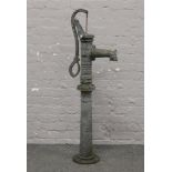 An ornate cast iron hand operated water pump standing 125cm high.