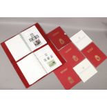 Two folders of Royal Events stamps by Stanley Gibbons, along with four Isle of Man stamps year books