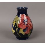 A Moorcroft blue ground baluster shape vase, in the Hibiscus design c. 1930s.