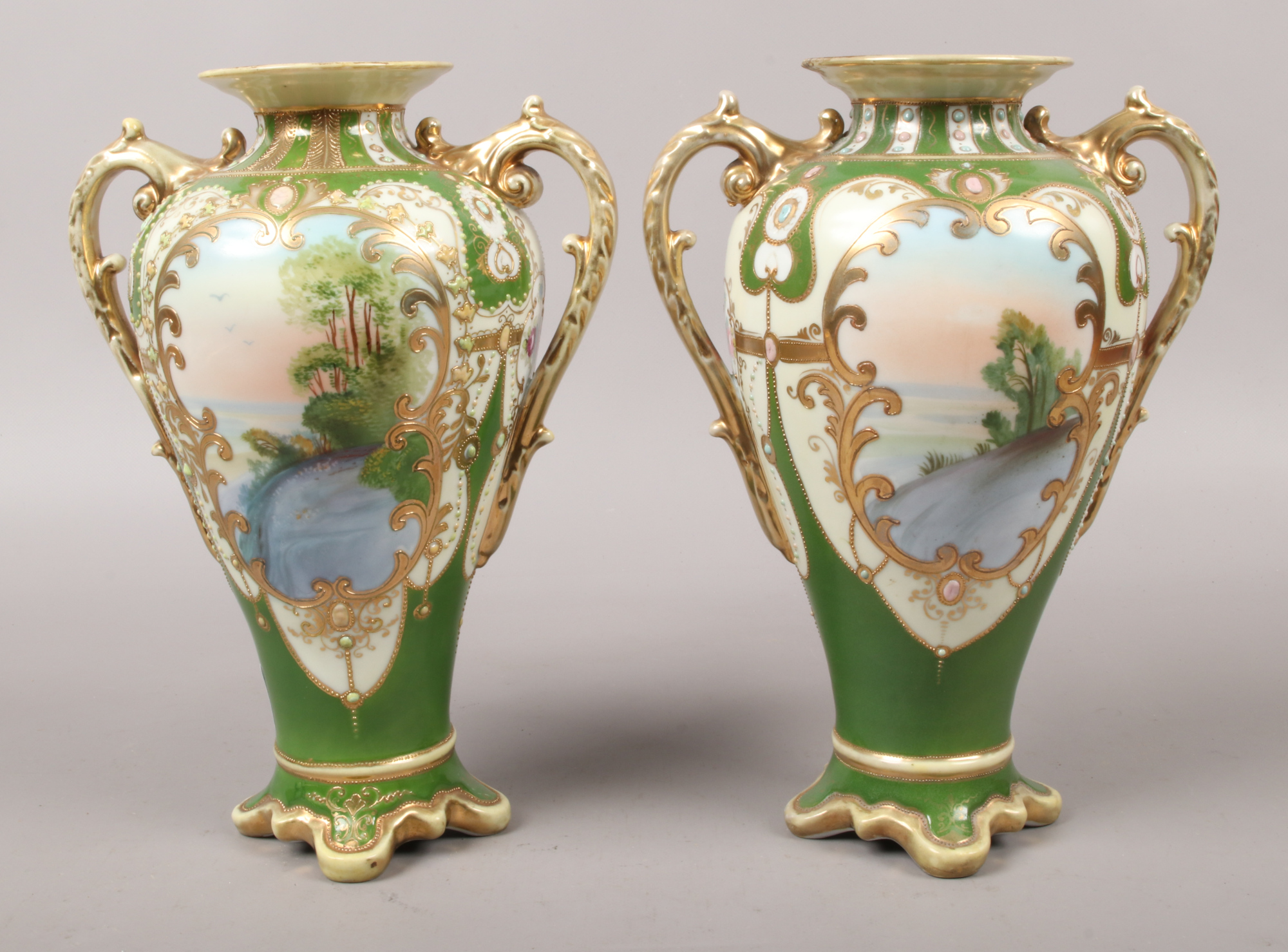 A pair of Noritake porcelain mantle urns each with gilt decoration over green ground and hand