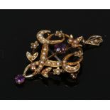 An Edwardian 9ct gold brooch / pendant set with amethysts and seed pearls.