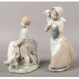 Two Nao porcelain figures one of a young woman and lamb, the other a boy and ram (damaged).