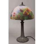 A bronze effect table lamp with reverse hand painted glass shade, decorated with flowers, height