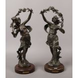 A pair of French Spelter figures on hardwood stands, marked La Paix and La Guerre.
