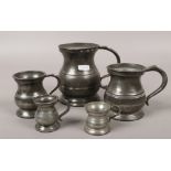 A set of five graduated baluster pewter mugs.