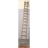 A vintage wooden double ladder with 15 rungs.