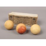 Three George V boxed carved ivory billiard balls by makers Burroughs & Watts Ltd, 4.75 diameter,