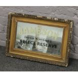 A gilt framed Jameson Irish Whisky advertising mirror.