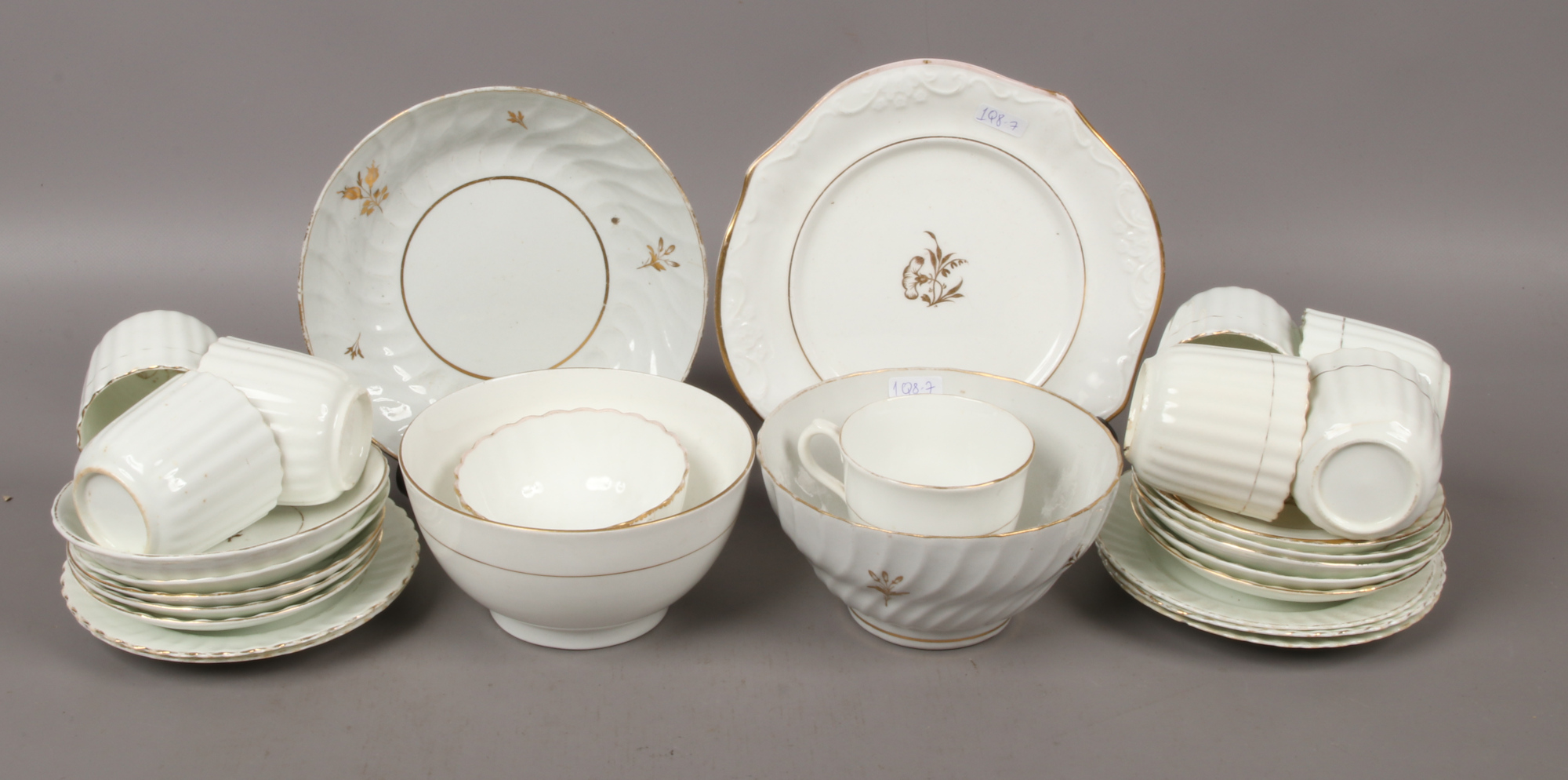 A quantity of 19th century bone china teawares with gilded decoration including slop bowls, cups and