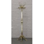 A gilt metal and onyx coatstand raised on four lion paw figural feet.Condition report intended as