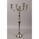 A large white metal five branch candelabra,