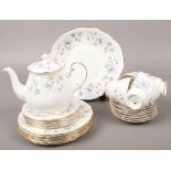 A Colcough bone china part tea set decorated with trailing flowers including tea pot, cups and