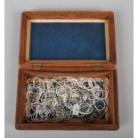 A wooden box and contents of 23 necklaces, mainly silver.