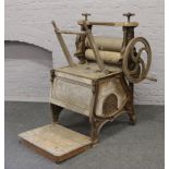 A Victorian cast iron and pine clothes washer and mangle by T Briggs & Sons top of Albion Street