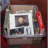 A box of kiloware along with Stanley Gibbons reference books etc.