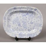 A Twigg Newhall pottery blue and white meat plate decorated with flower sprigs over a cell ground,