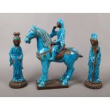 A pair of Chinese blue glazed earthenware models of immortals, along with a Tang style horse and