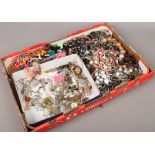 A tray of costume jewellery including necklaces, beads, pendants on chains etc.