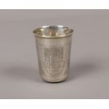 A Russian silver beaker engraved with landscape and foliage panels, punch marks, 22 grams.