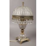 A gilt metal and cut glass table lamp.