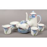 A Shelley bone china six part coffee set decorated with flowers.