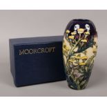 A boxed Moorcroft vase designed by Kerry Goodwin with wild yellow flowers, 18.5cm.