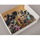 A box of dress and costume jewellery including beads, bangles, simulated pearls, coloured stone