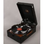 A vintage HMV picnic gramophone with winding handle.