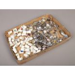 A tray of silver plate collectors / souvenir spoons and bone china thimbles.