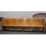 An early - mid 20th century oak and pine panelled church pew 280cm long.