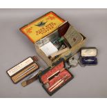A blue bird chocolate toffee tin and contents of collectables to include silver and marcasite watch,