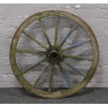 An iron old wooden 12 spoke cartwheel.