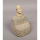 A carved stone tribal stand with separate carved head, the base decorated with incised geometric