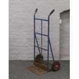 A metal framed sack barrow.