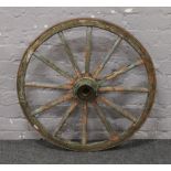 An iron old wooden 12 spoke cartwheel.