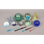 A quantity of mostly glass paperweights to include Selkick glass, glass pen examples etc.