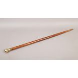 A sectional hardwood walking stick with brass mounts, concealed compass and spirit flask.