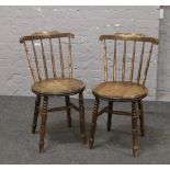 A pair of hardwood spindle back chairs.