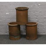 Three terracotta chimney pots.