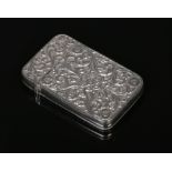 A 19th century Anglo Indian silver card case with hinged cover. Decorated with repousse flowers