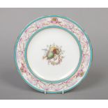A Minton lobed plate painted by Desire Leroy in the Sevres style. Having a turquoise and gilt border