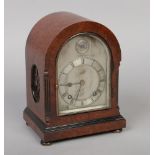 A burr walnut cased dome top mantel clock of small proportions, having reeded canted corners and