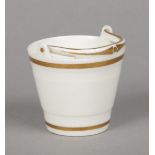 A rare Rockingham miniature model of a bucket with banded tapering sides and lowered handle.