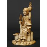 A Japanese Meiji period carved ivory okimono. Formed as a seated sage. Signed with a lacquer