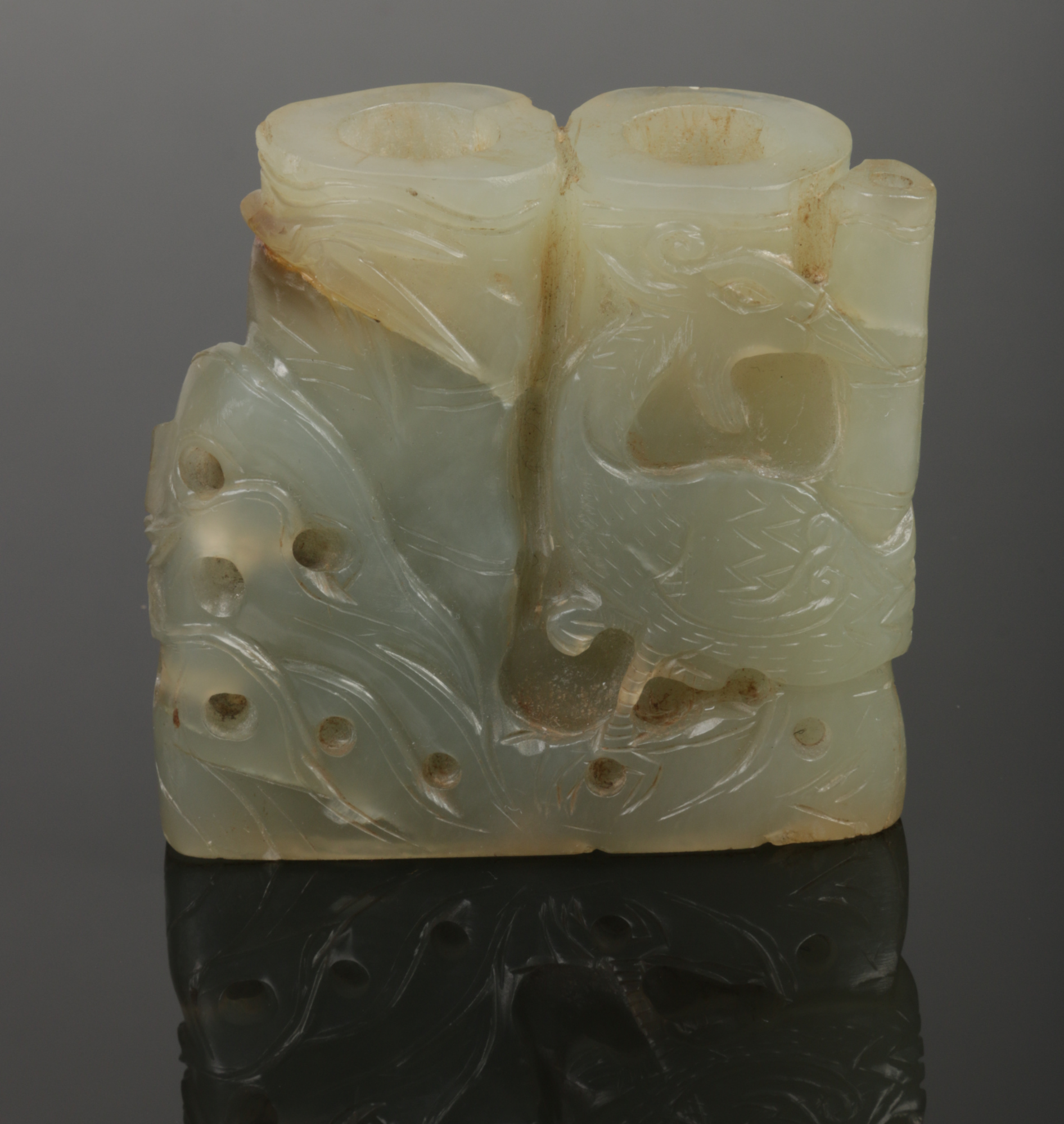A Chinese celadon jade brush washer. Carved in the form of a bamboo root and with a phoenix
