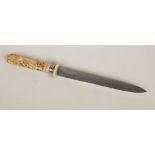 A Mughal Indian ivory handled dagger. Carved to the grip with a pair of figures and pierced